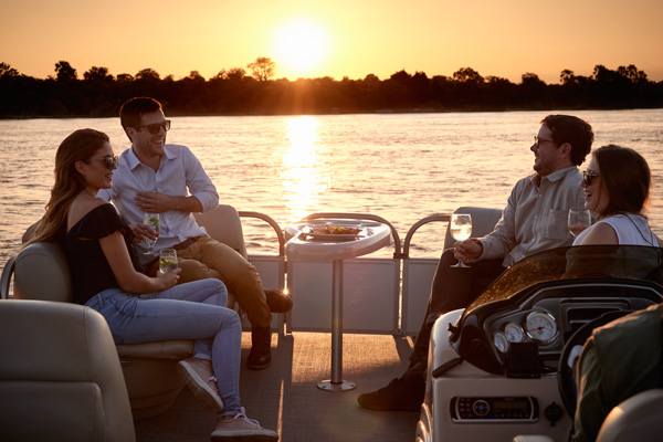 A group of people sitting on a boat Description automatically generated with medium confidence